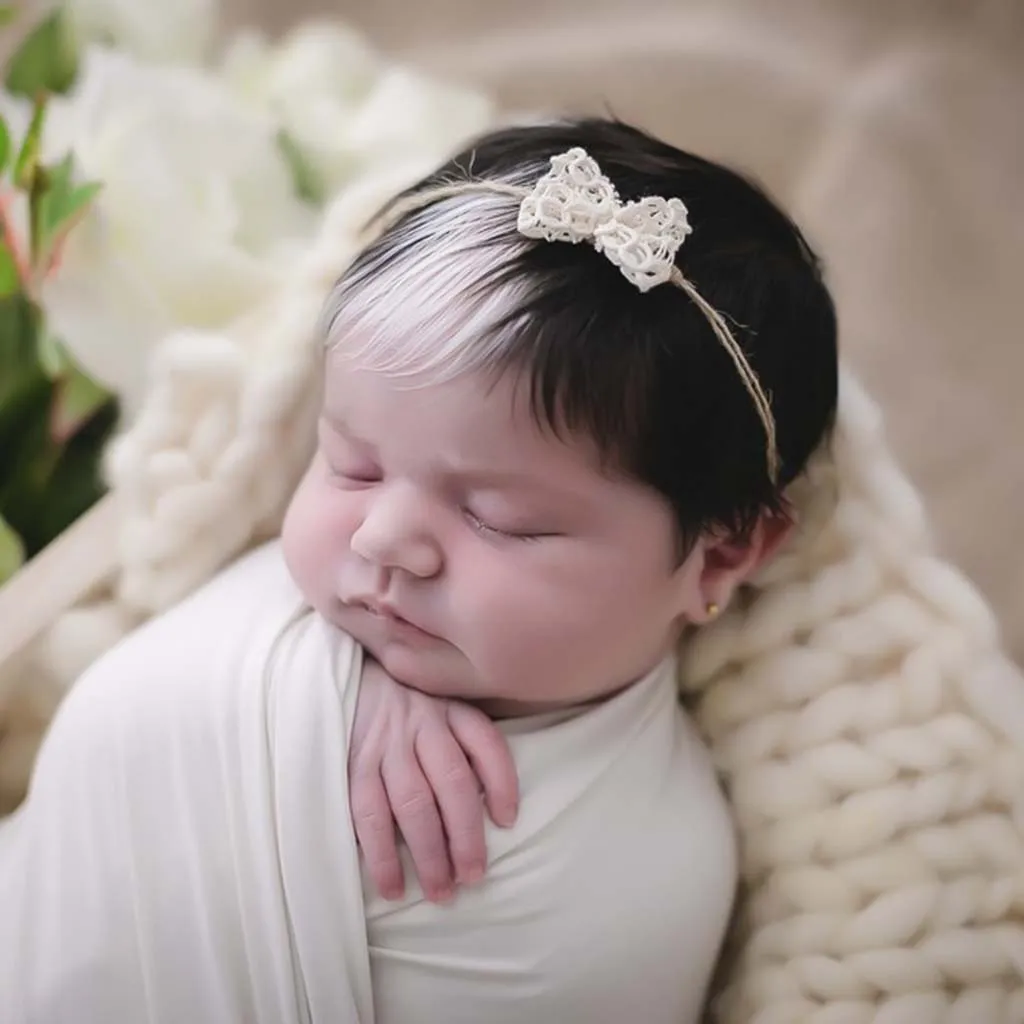 The newborn with white hair exudes a unique and captivating charm that captures everyone’s attention.